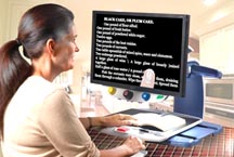 A woman uses the TOPAZ XL HD Freeze Frame feature to follow the text of a recipe