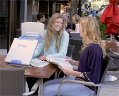 Students at an outdoor cafe using the TOPAZ PHD to study